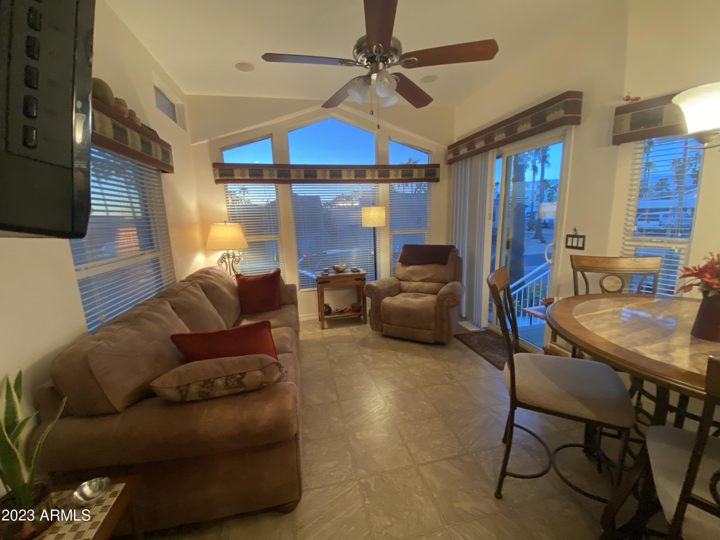 1358 Kiowa Circle, Unit 358 Apache Junction, AZ 85119 - Photo 2 of 37 a living room with furniture a ceiling fan and a window