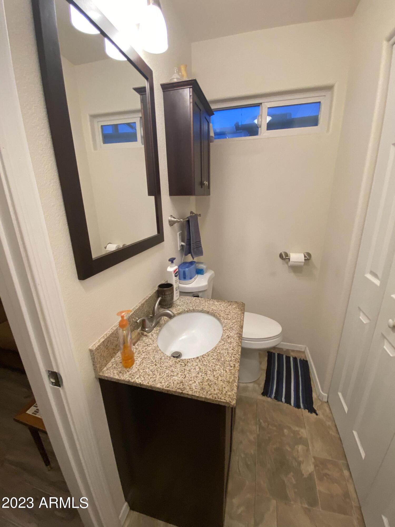 1358 Kiowa Circle, Unit 358 Apache Junction, AZ 85119 - Photo 23 of 37 a bathroom with a sink and a mirror