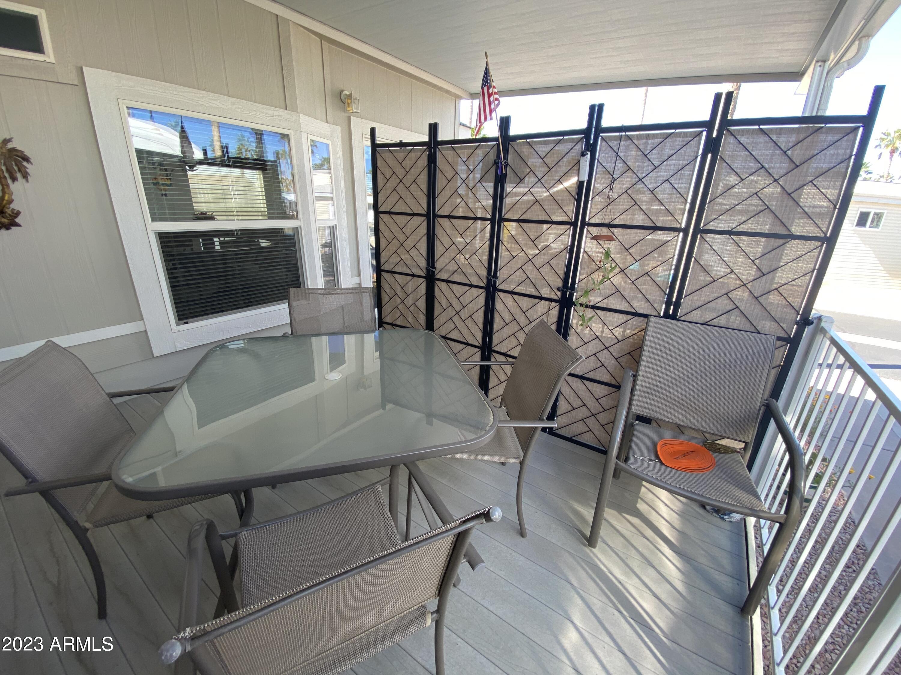 1358 Kiowa Circle, Unit 358 Apache Junction, AZ 85119 - Photo 26 of 37 a balcony with furniture and wooden floor
