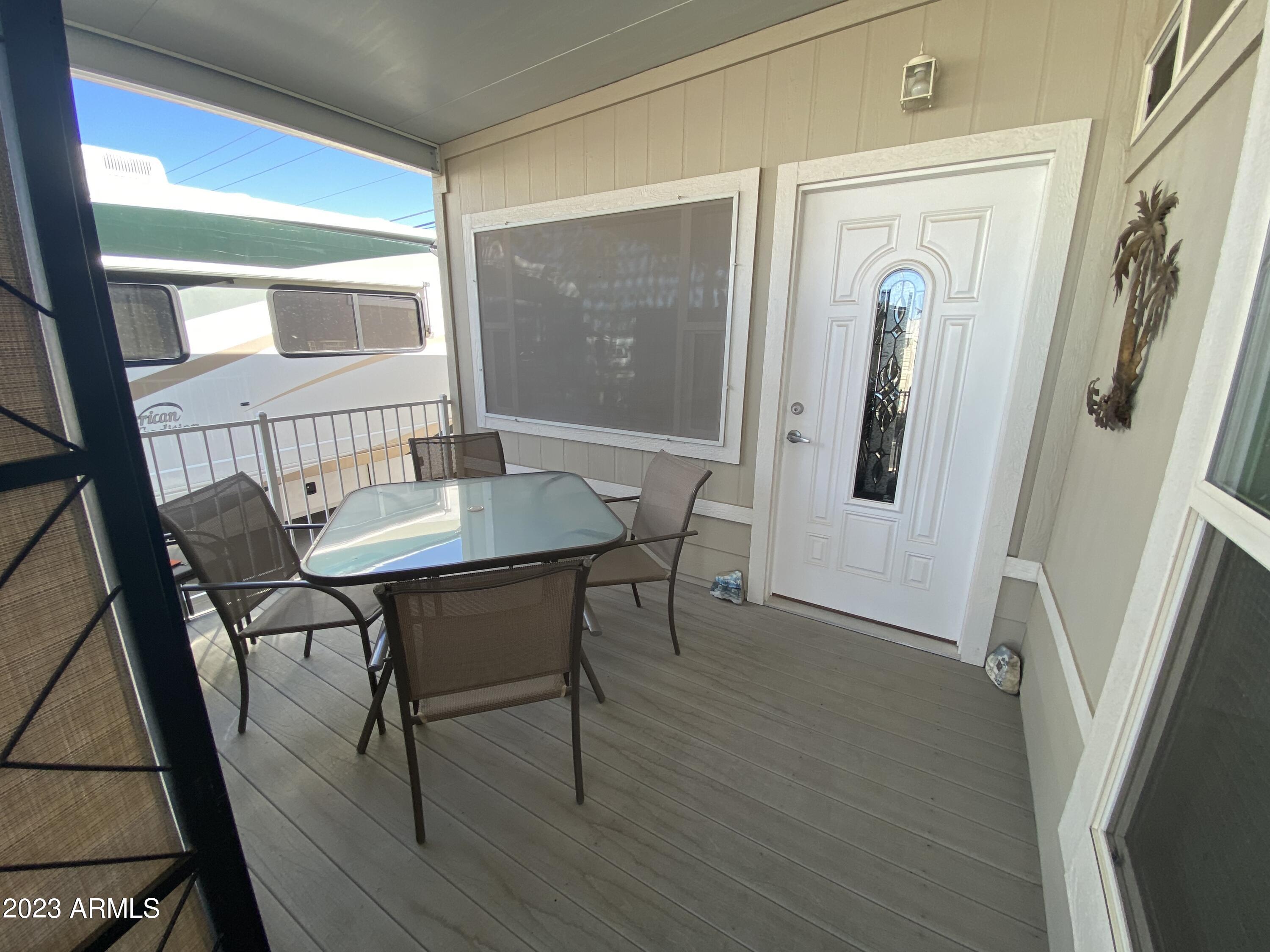 1358 Kiowa Circle, Unit 358 Apache Junction, AZ 85119 - Photo 27 of 37 a view of a dining room with furniture window and wooden floor