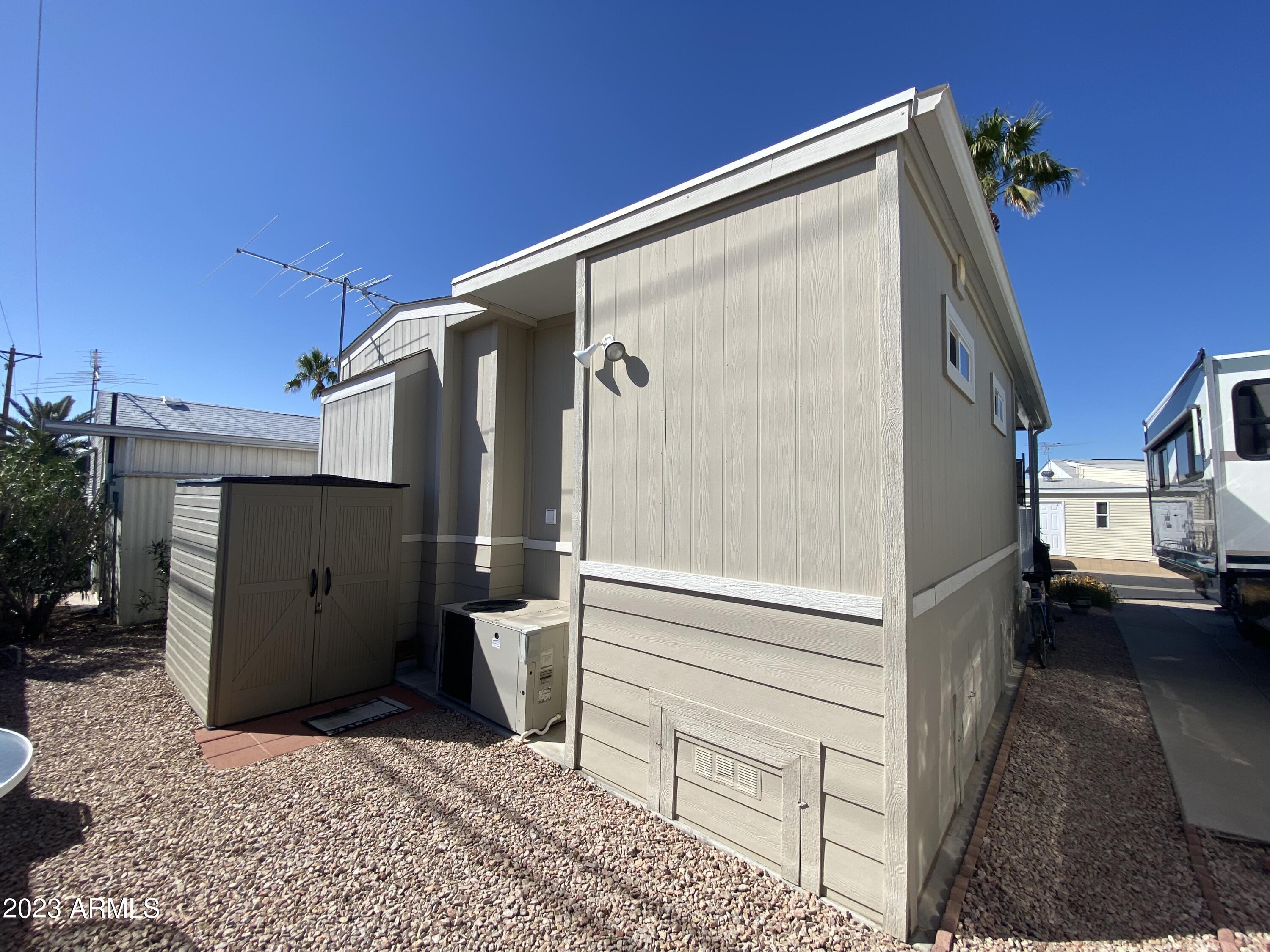 1358 Kiowa Circle, Unit 358 Apache Junction, AZ 85119 - Photo 31 of 37 a view of a house with a wooden bench