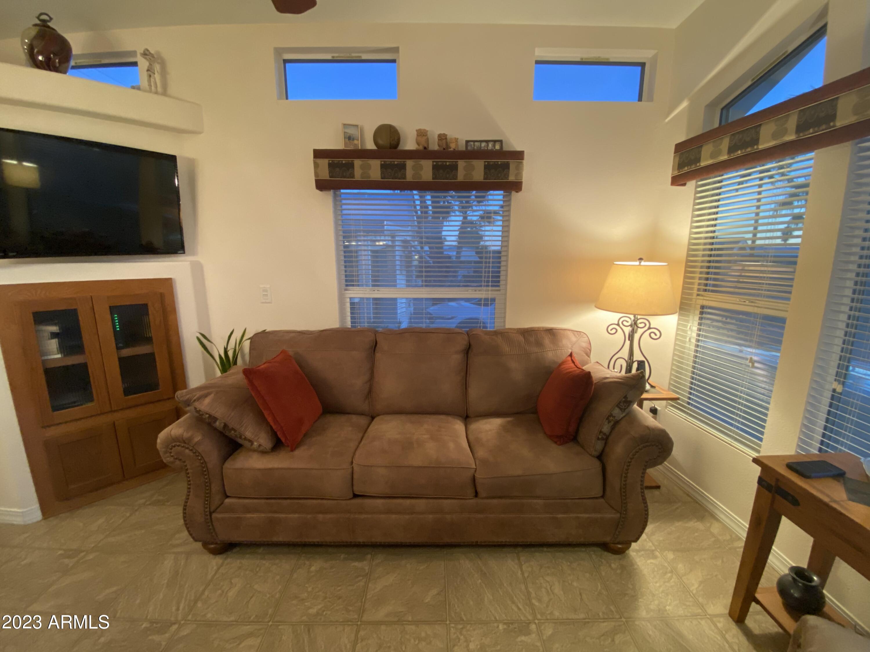 1358 Kiowa Circle, Unit 358 Apache Junction, AZ 85119 - Photo 6 of 37 a living room with furniture and a flat screen tv