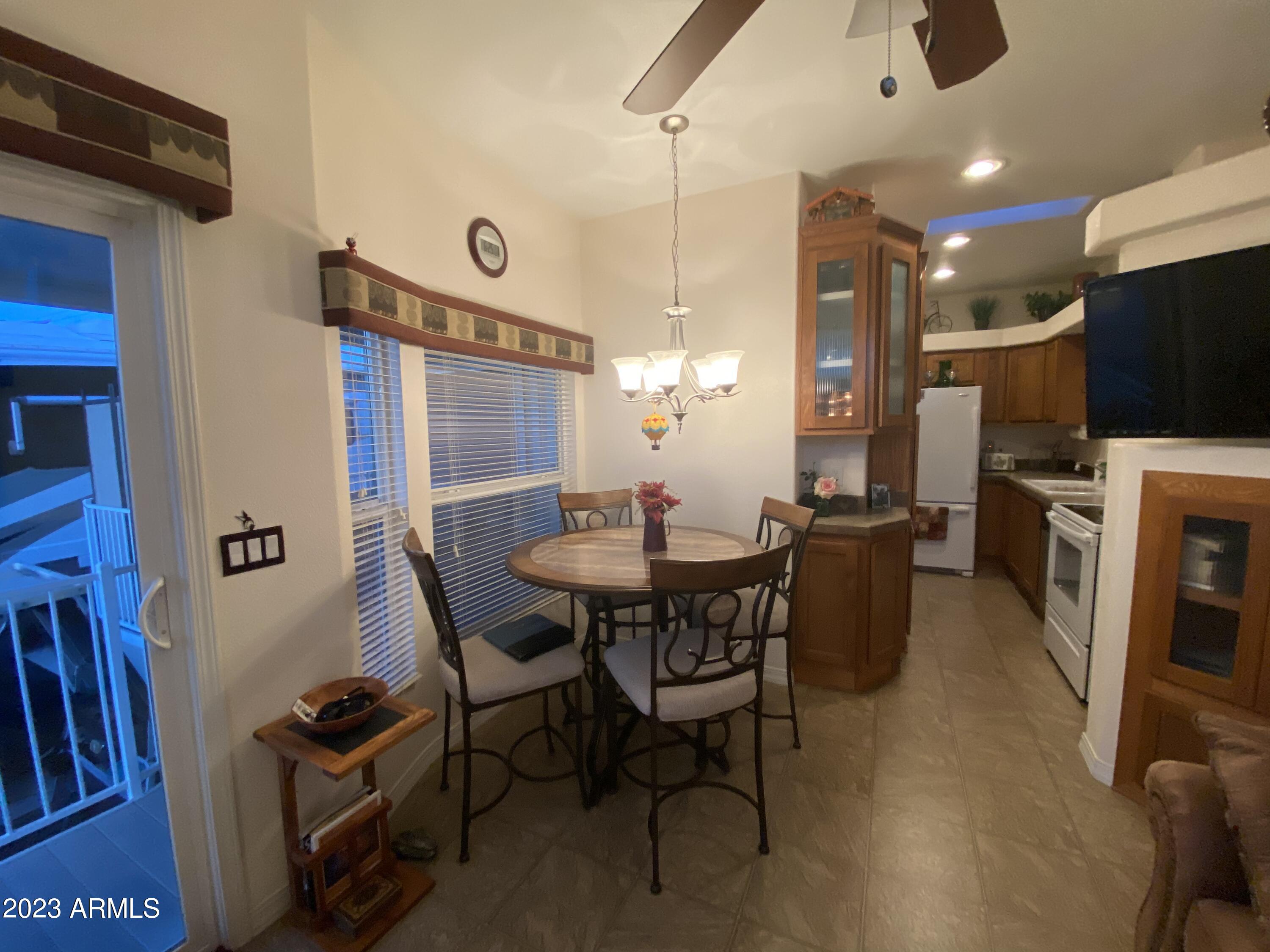 1358 Kiowa Circle, Unit 358 Apache Junction, AZ 85119 - Photo 7 of 37 a view of a livingroom with furniture and a flat screen tv