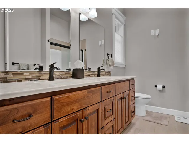a bathroom with a sink a toilet and a mirror