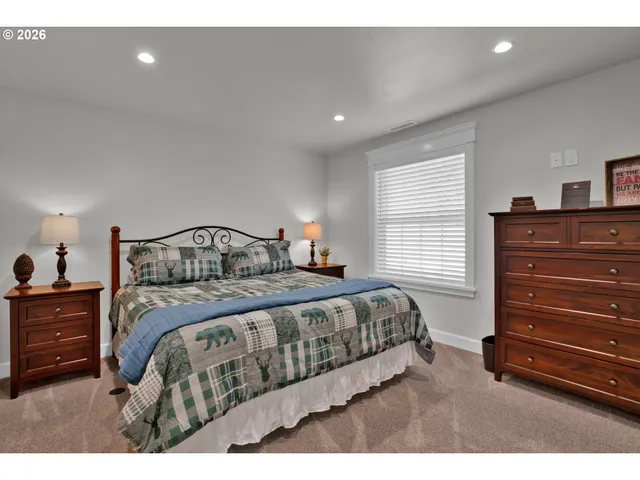 a bedroom with a bed and a dresser