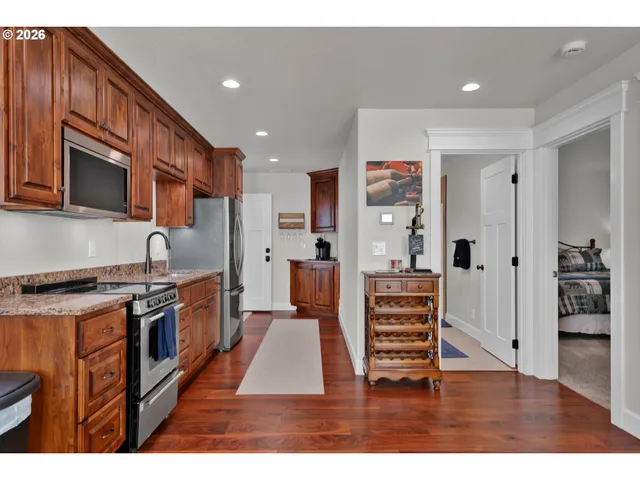 a kitchen with stainless steel appliances granite countertop a stove a sink and a refrigerator