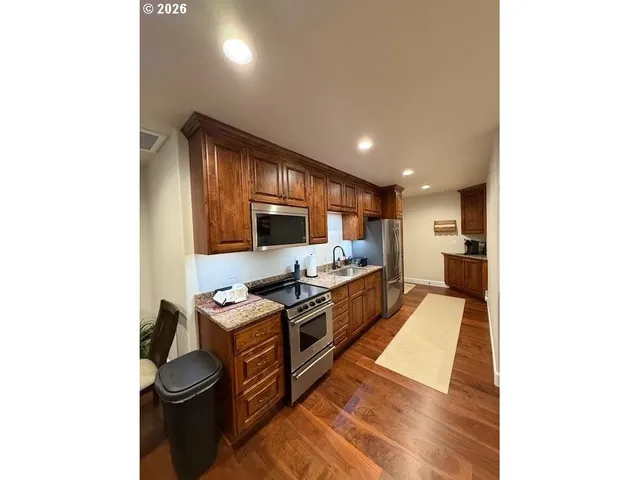 a kitchen with stainless steel appliances a stove and a refrigerator