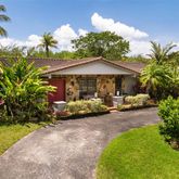 a view of a patio with table and chairs under an umbrella