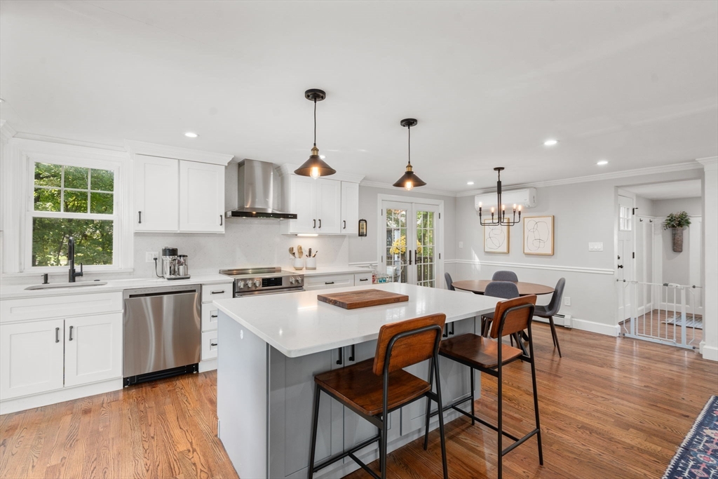 317 Dedham Avenue Needham, MA 02492 - Photo 12 of 29 a kitchen with stainless steel appliances a sink a stove a table and chairs
