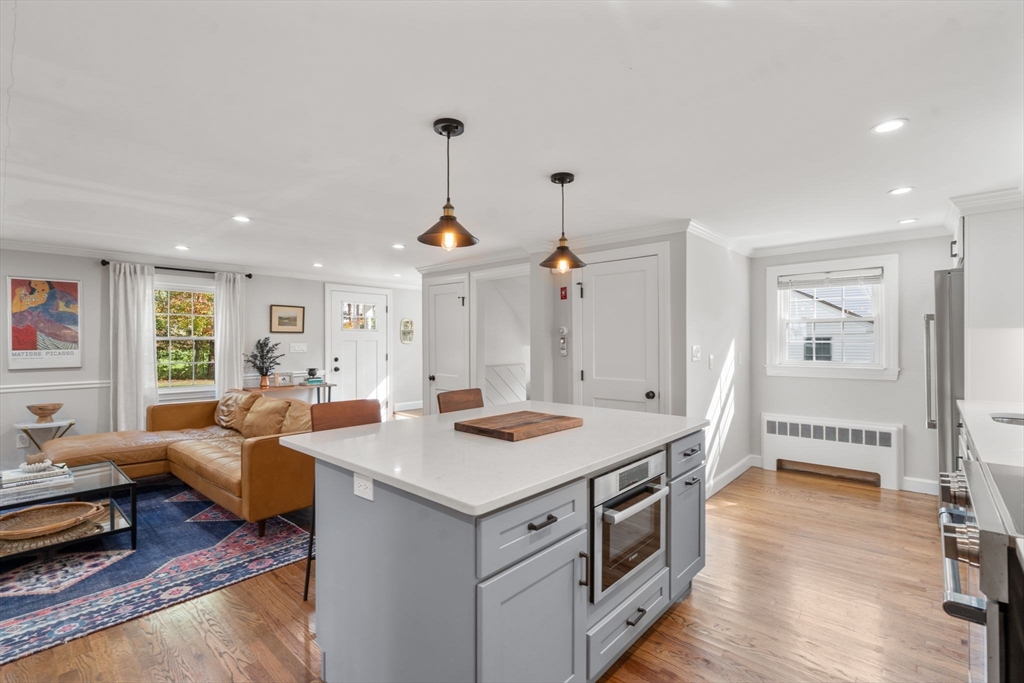 317 Dedham Avenue Needham, MA 02492 - Photo 9 of 29 a view of kitchen island sink stove and living room