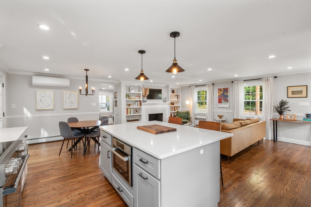 317 Dedham Avenue Needham, MA 02492 - Photo 10 of 29 a kitchen that has a lot of cabinets a sink and wooden floor