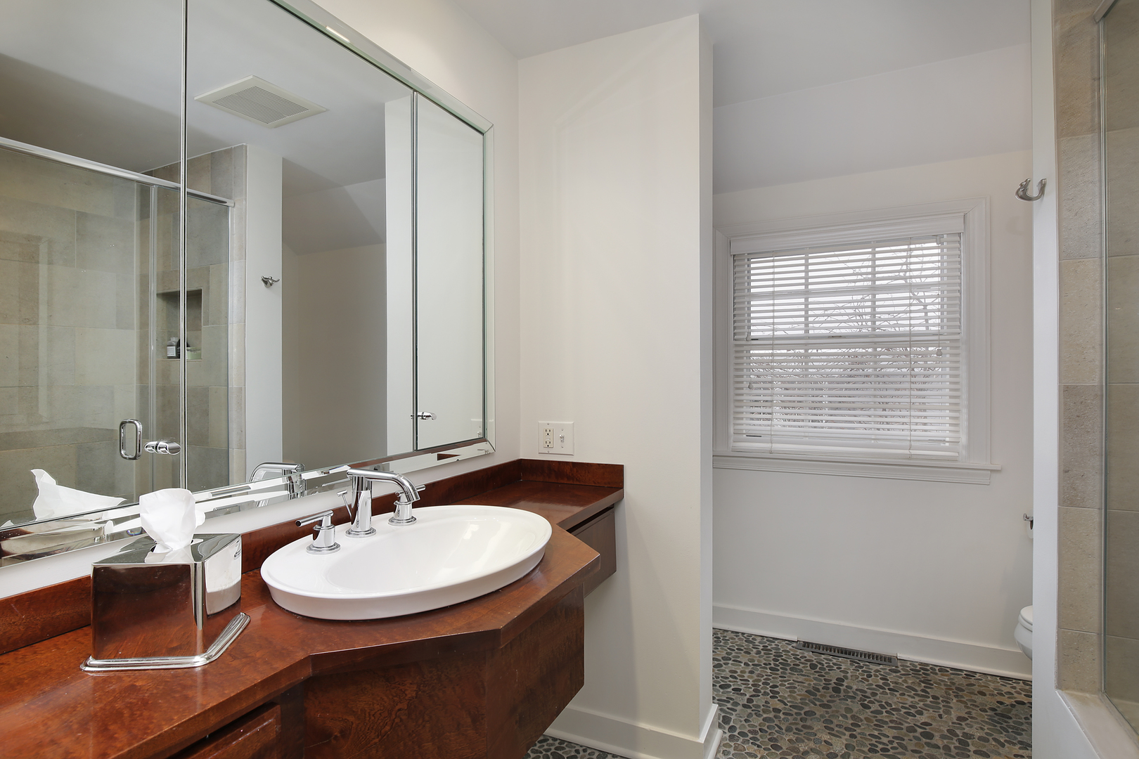 1309 Ridgewood Drive Northbrook, IL 60062 - Photo 9 of 18 a bathroom with a sink double vanity and a mirror