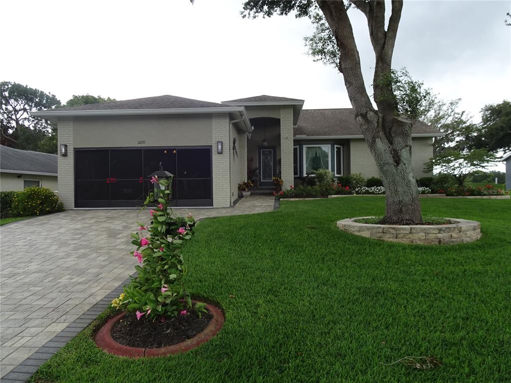2251 Terrace View Lane Spring Hill, FL 34606 - Photo 1 of 1 Green lawn, flowering plants, lovely curb appeal.