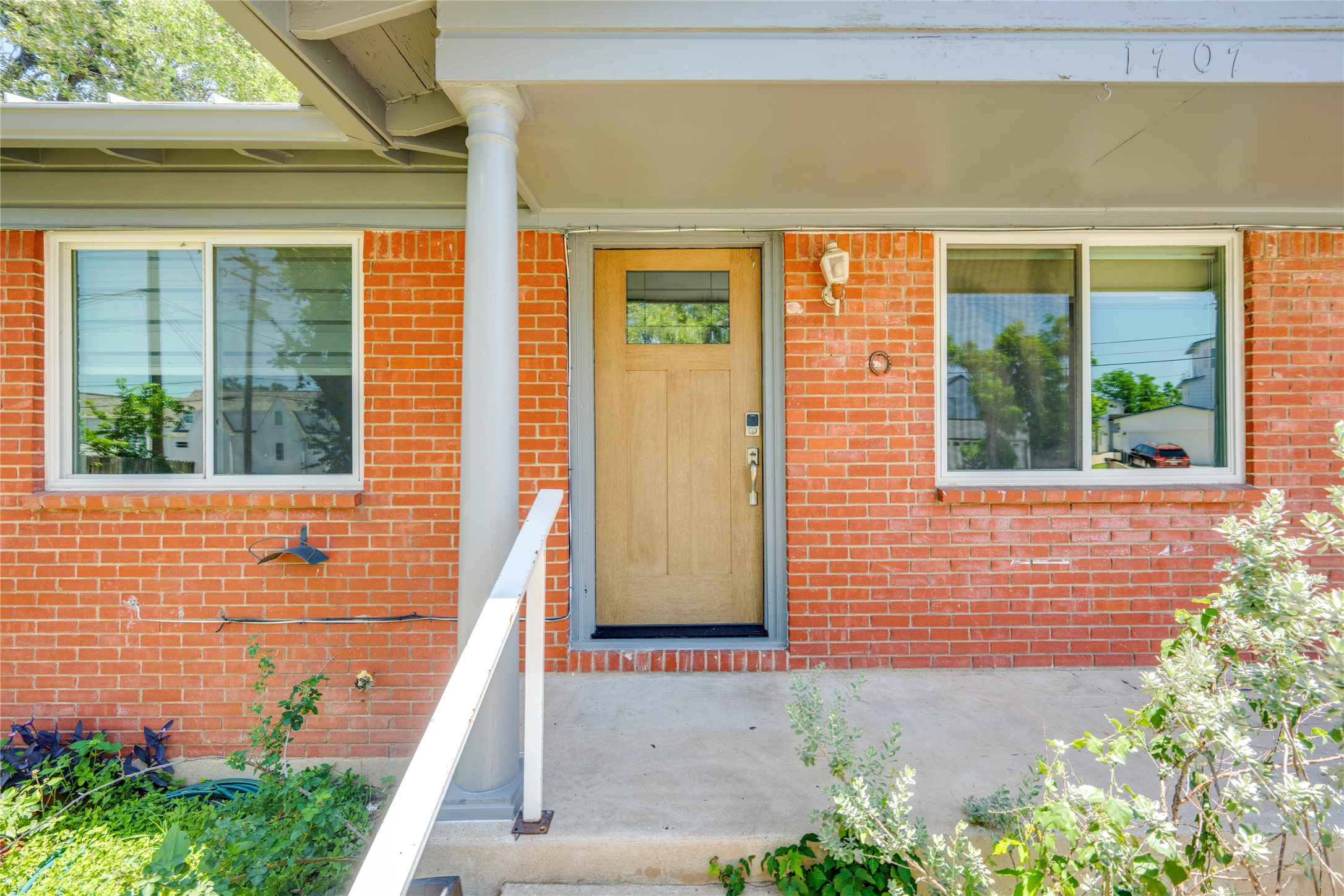 1707 Overhill Drive Austin, TX 78721 - Photo 3 of 36 A classic brick exterior with a welcoming porch entry and a solid wood door.
