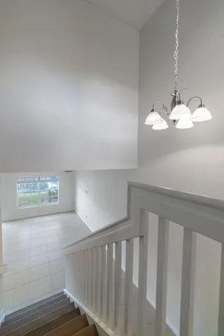a view of a livingroom with wooden floor and stairs