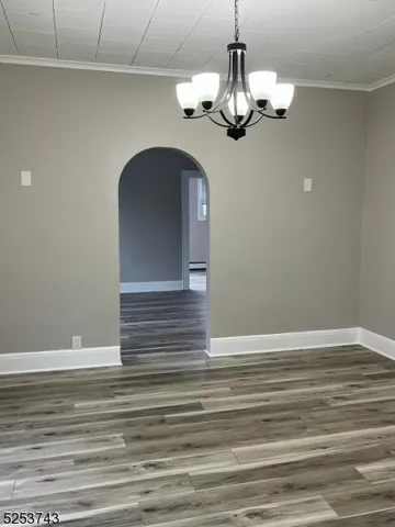 a view of a chandelier fan and wooden floor
