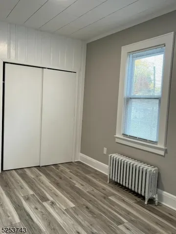 a view of a room that has a bed and a window