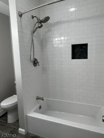 a bathroom with a bathtub and a toilet