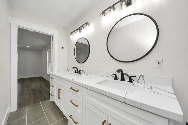 a bathroom with a sink mirror vanity and toilet