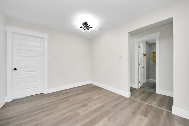 a view of kitchen with wooden floor and electronic appliances