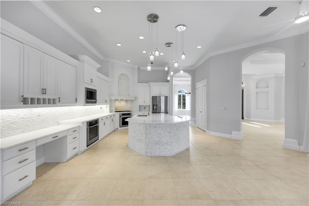 10072 Orchid Ridge Lane Estero, FL 34135 - Photo 17 of 48 a large white kitchen with a large window