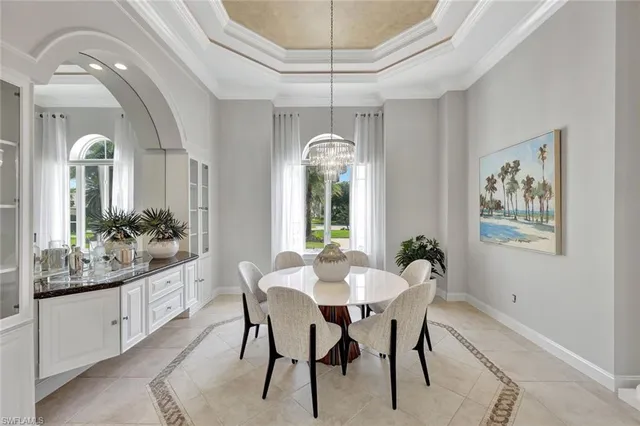 a dining room with furniture a chandelier and window