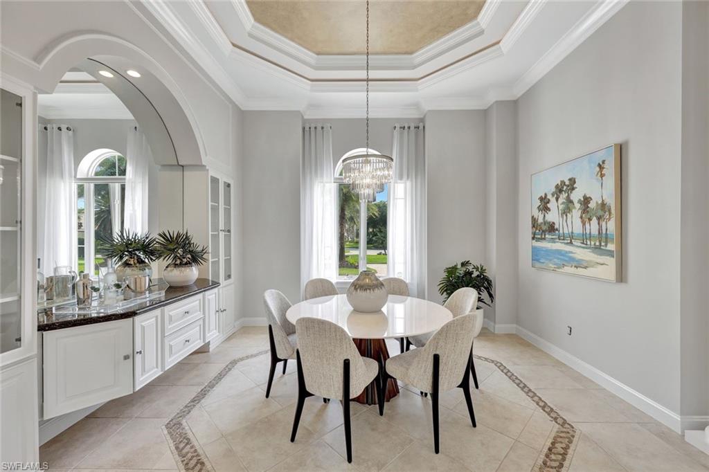 10072 Orchid Ridge Lane Estero, FL 34135 - Photo 21 of 48 a dining room with furniture a chandelier and window