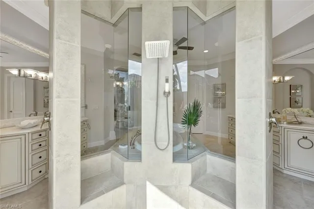a bathroom with a glass shower door and a sink