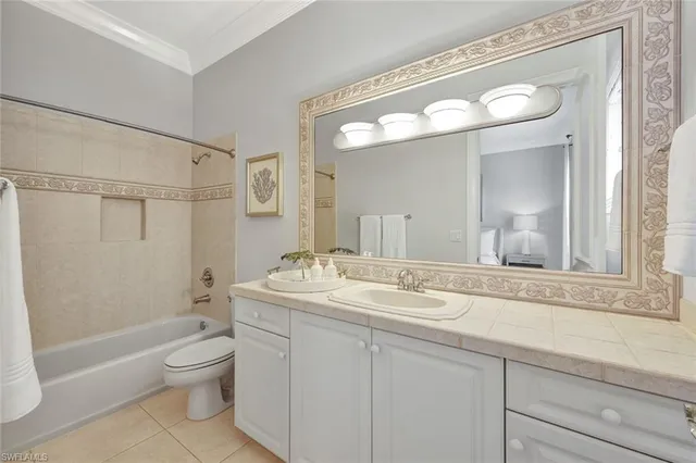 a bathroom with a granite countertop sink toilet a large mirror a bathtub and shower