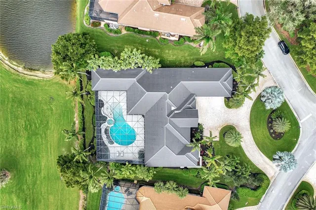 an aerial view of a house with garden space and a lake view