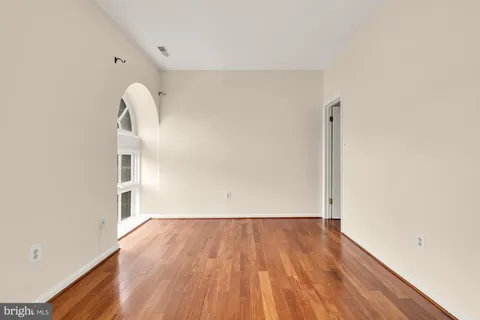 a view of a room with wooden floor