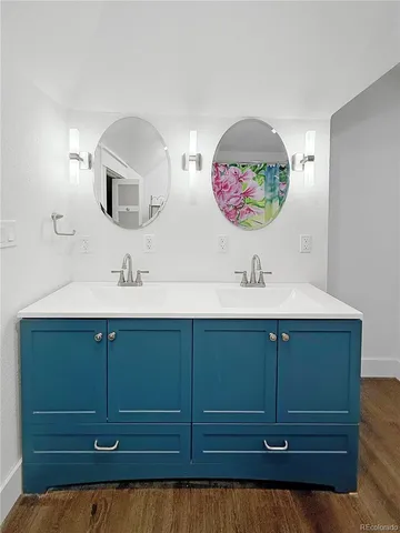 a bathroom with a sink mirror and vanity