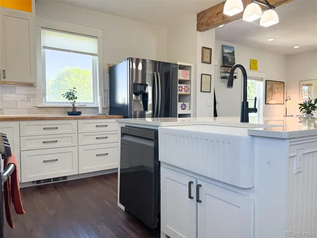 a kitchen with stainless steel appliances kitchen island granite countertop a refrigerator and a stove