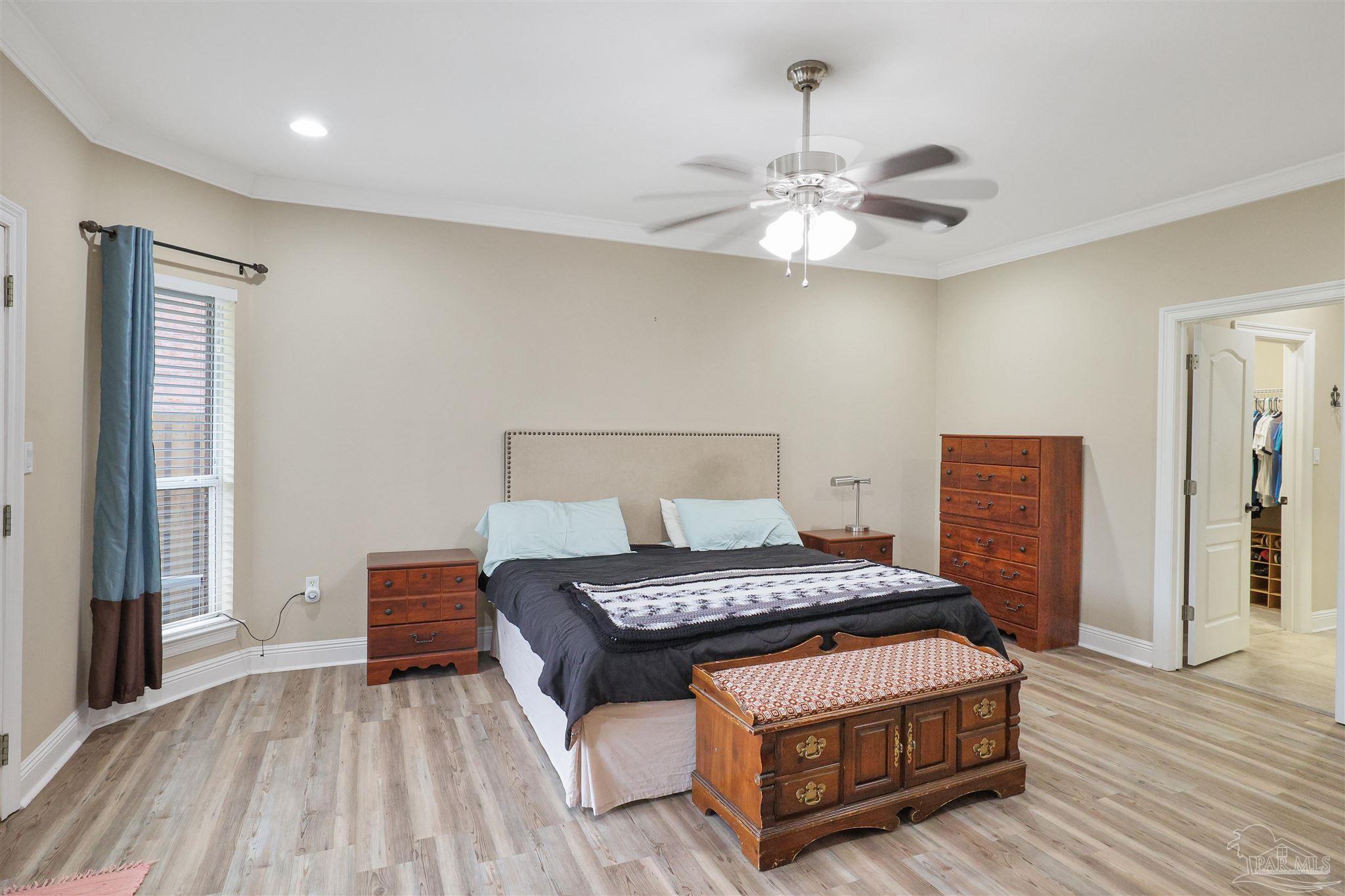 2822 Frederick Street Cantonment, FL 32533 - Photo 12 of 42 a bedroom with a bed and a chandelier