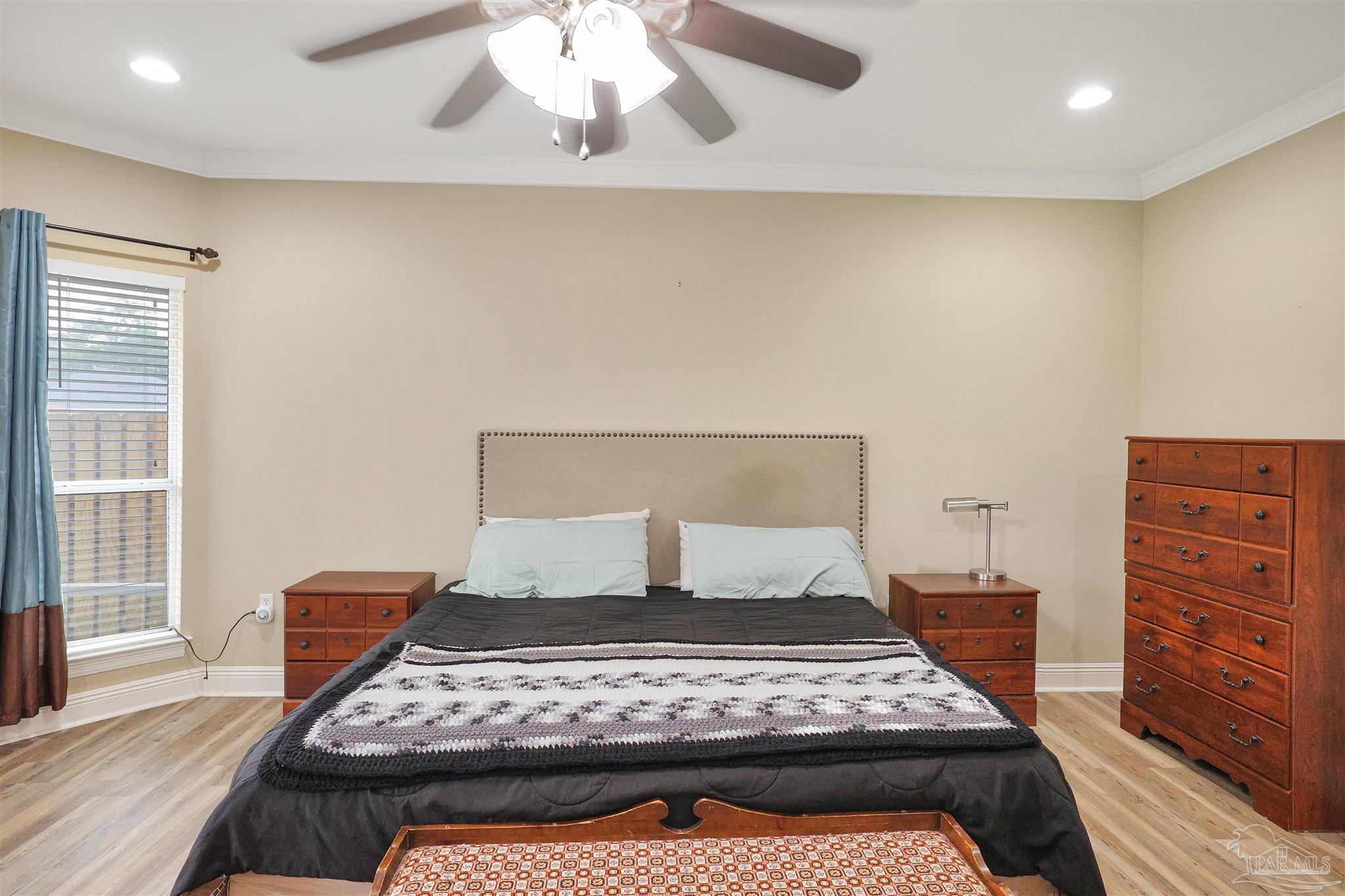 2822 Frederick Street Cantonment, FL 32533 - Photo 13 of 42 a bedroom with a bed and wooden floor