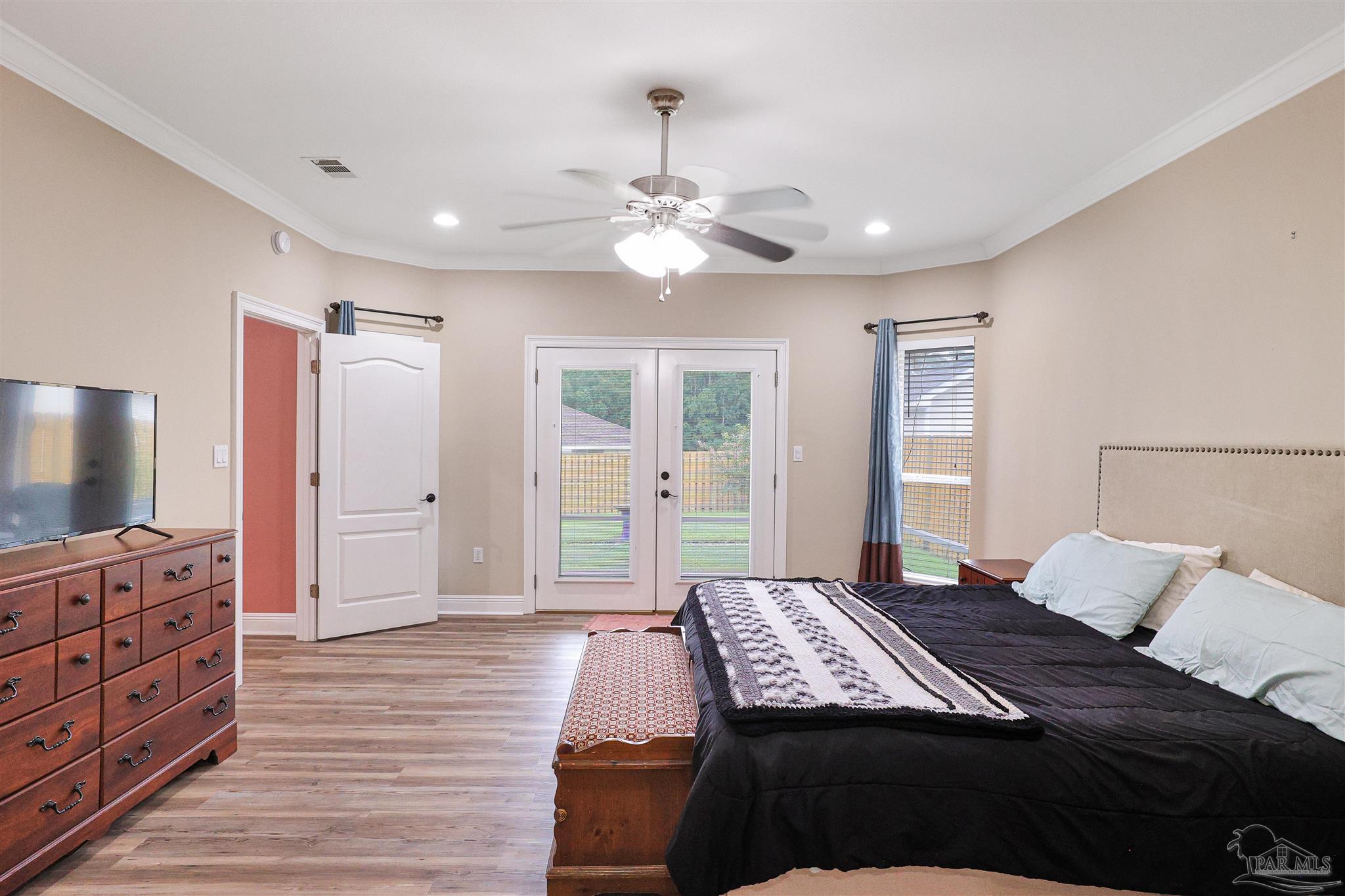 2822 Frederick Street Cantonment, FL 32533 - Photo 14 of 42 a bedroom with a bed and wooden floor