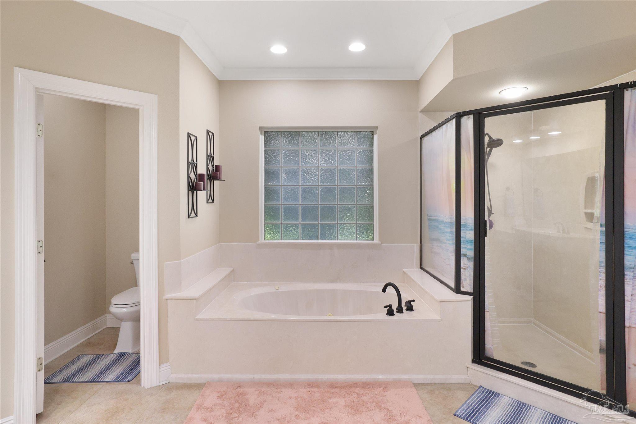 2822 Frederick Street Cantonment, FL 32533 - Photo 16 of 42 a bathroom with a bathtub and a shower