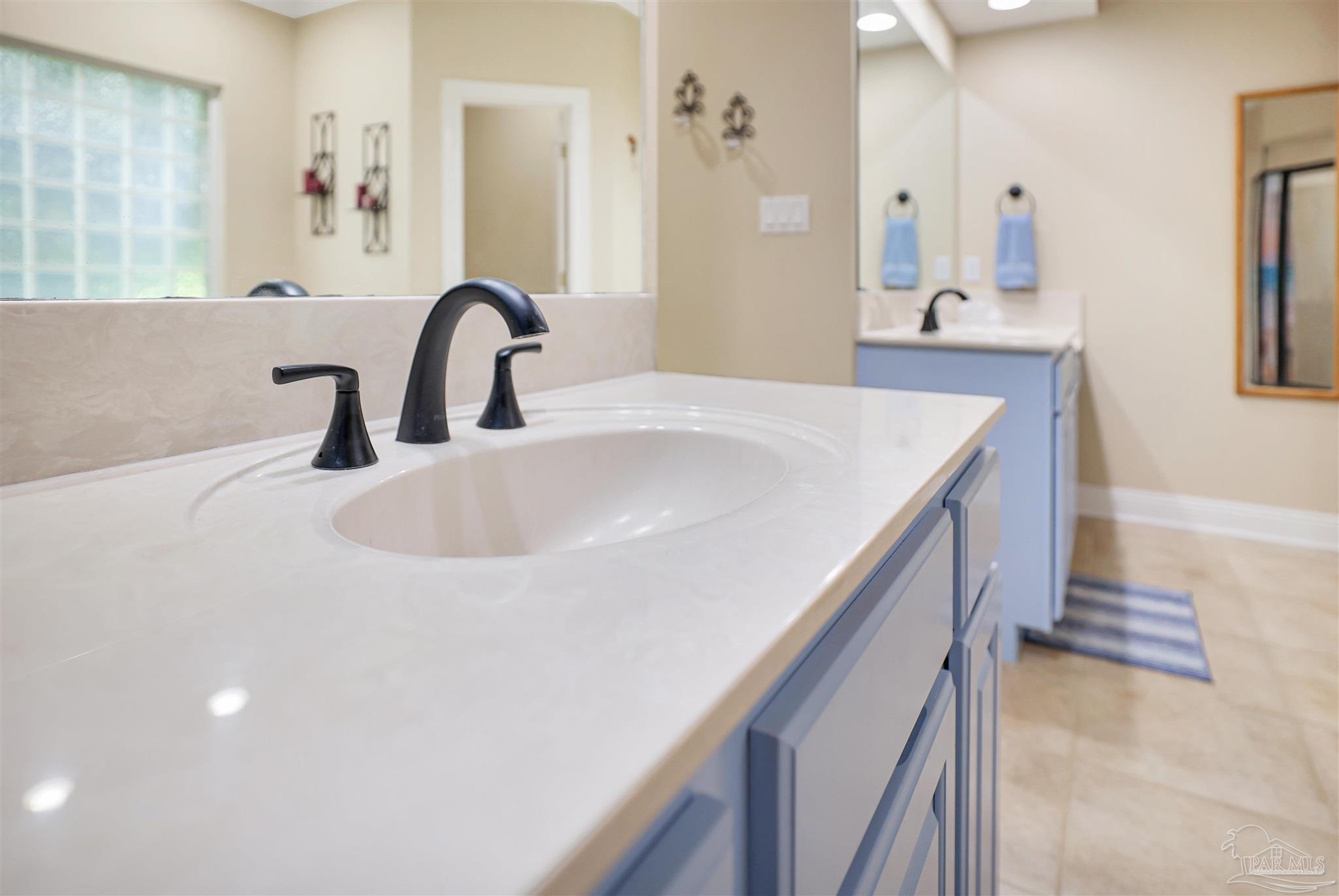 2822 Frederick Street Cantonment, FL 32533 - Photo 19 of 42 a bathroom with a sink and a mirror