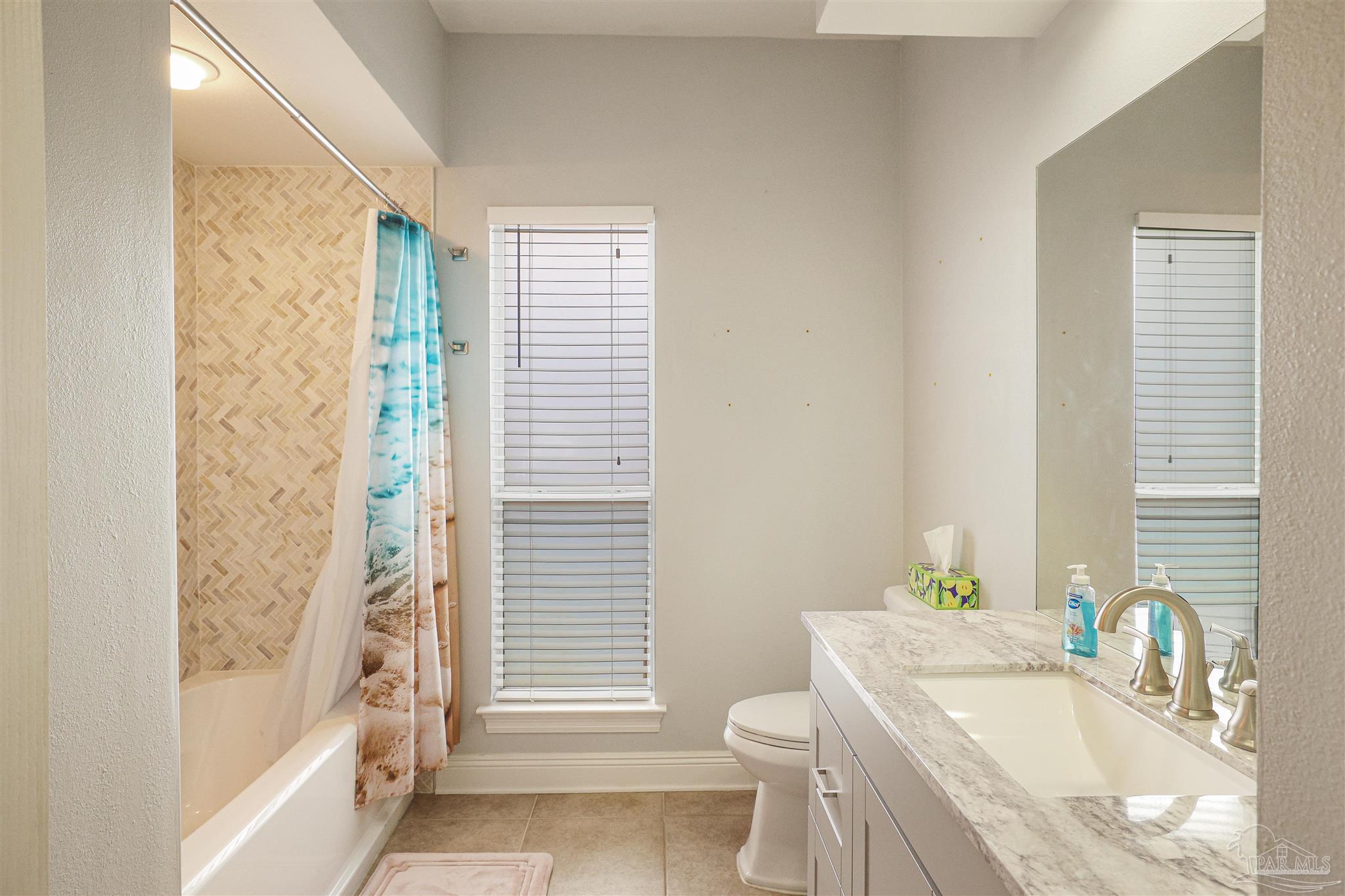 2822 Frederick Street Cantonment, FL 32533 - Photo 21 of 42 a bathroom with a granite countertop sink toilet and shower