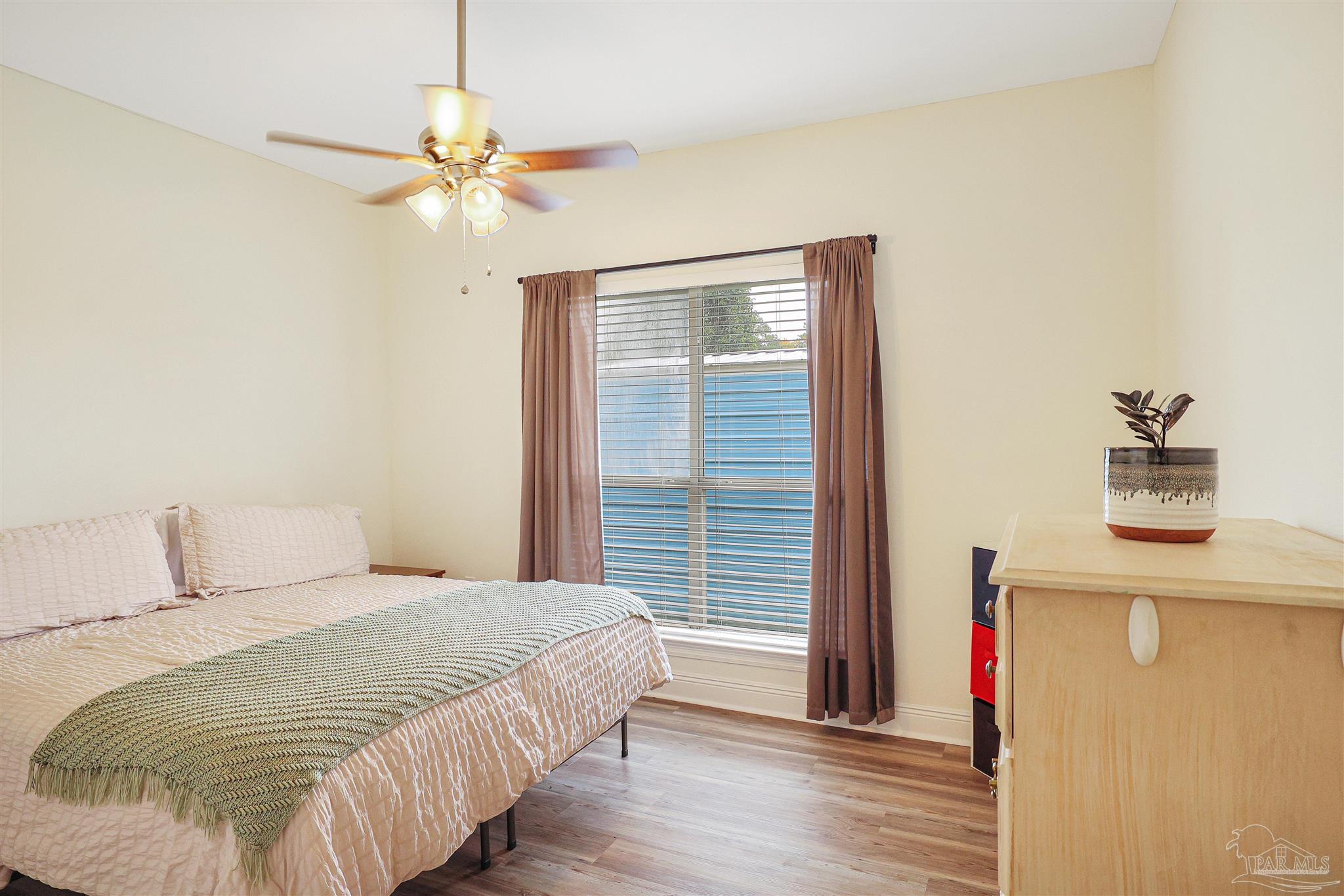 2822 Frederick Street Cantonment, FL 32533 - Photo 24 of 42 a bedroom with a bed and a chandelier