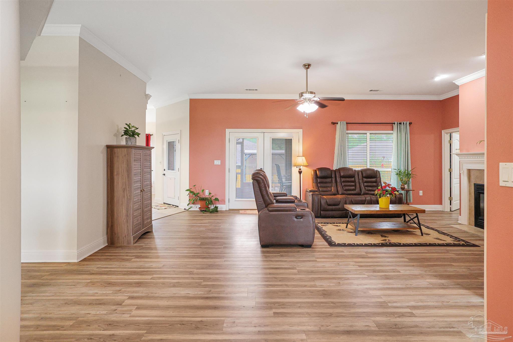 2822 Frederick Street Cantonment, FL 32533 - Photo 29 of 42 a living room with furniture and a chandelier