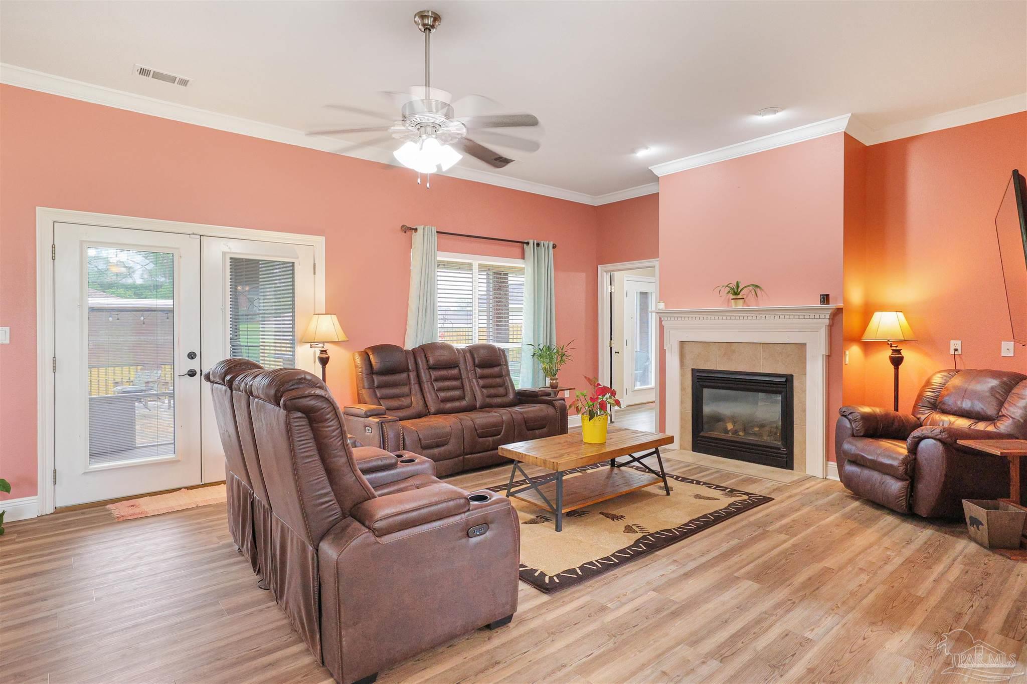 2822 Frederick Street Cantonment, FL 32533 - Photo 3 of 42 a living room with furniture and a fireplace