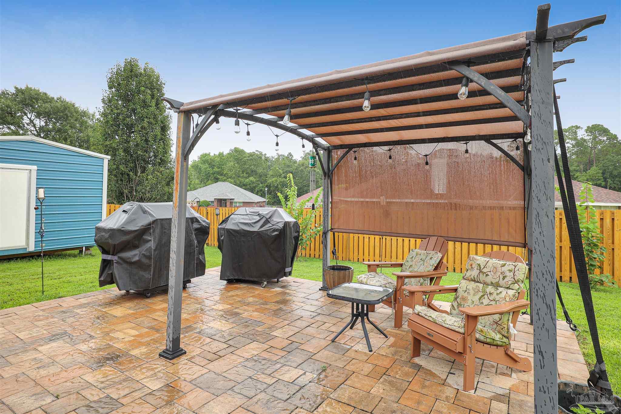 2822 Frederick Street Cantonment, FL 32533 - Photo 34 of 42 a backyard of a house with table and chairs