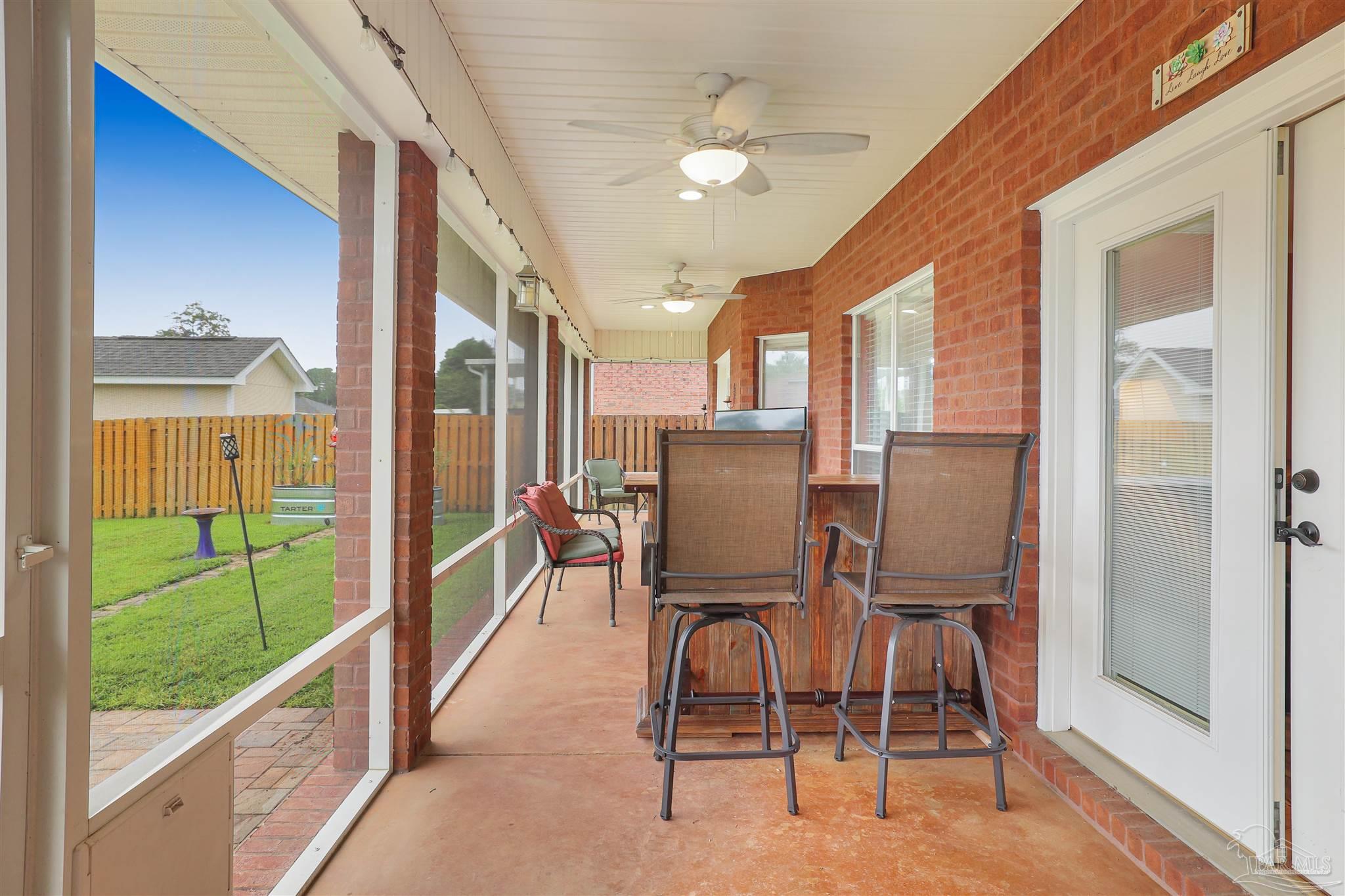 2822 Frederick Street Cantonment, FL 32533 - Photo 35 of 42 a dining room with furniture and a floor to ceiling window