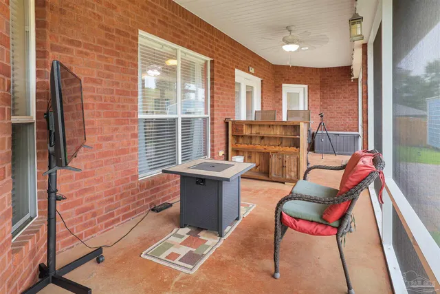 a view of living room kitchen with furniture and large windows
