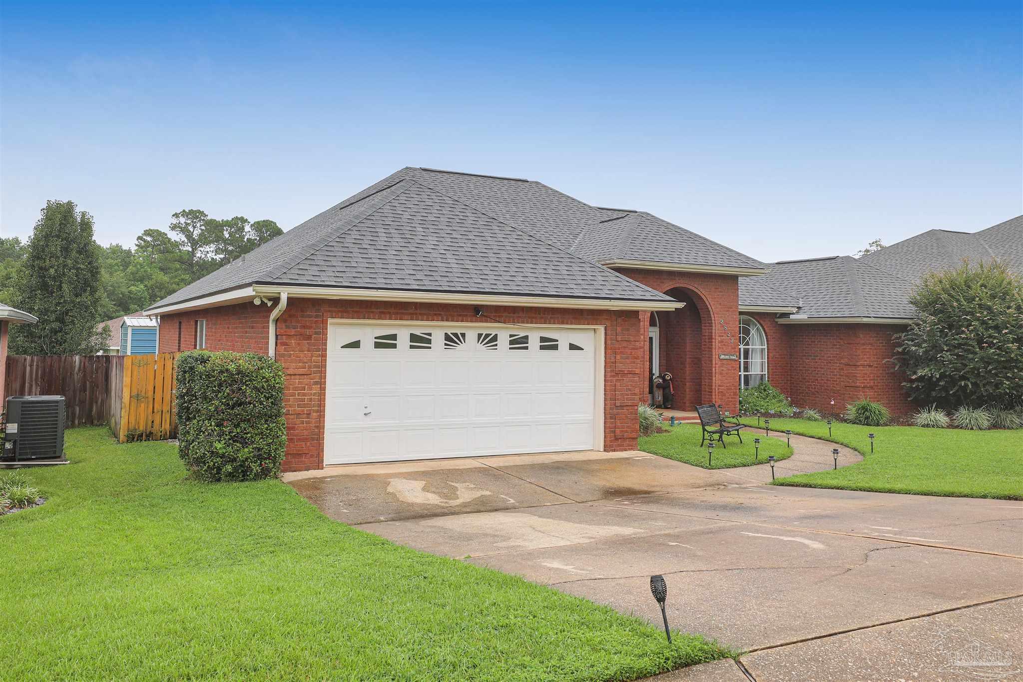 2822 Frederick Street Cantonment, FL 32533 - Photo 40 of 42 a front view of a house with a yard and garage