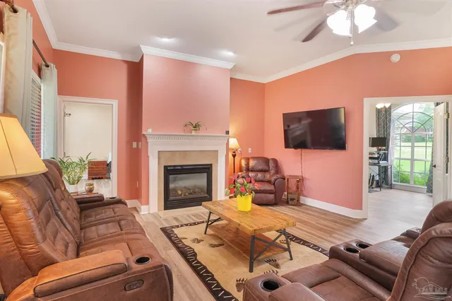 a living room with furniture a flat screen tv and a fireplace