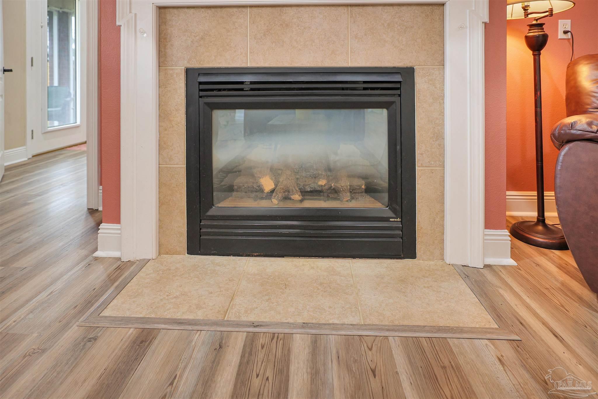 2822 Frederick Street Cantonment, FL 32533 - Photo 6 of 42 a view of a livingroom with wooden floor and a fireplace