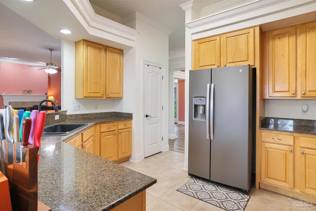 a kitchen with stainless steel appliances granite countertop a refrigerator a stove and a sink with wooden floor