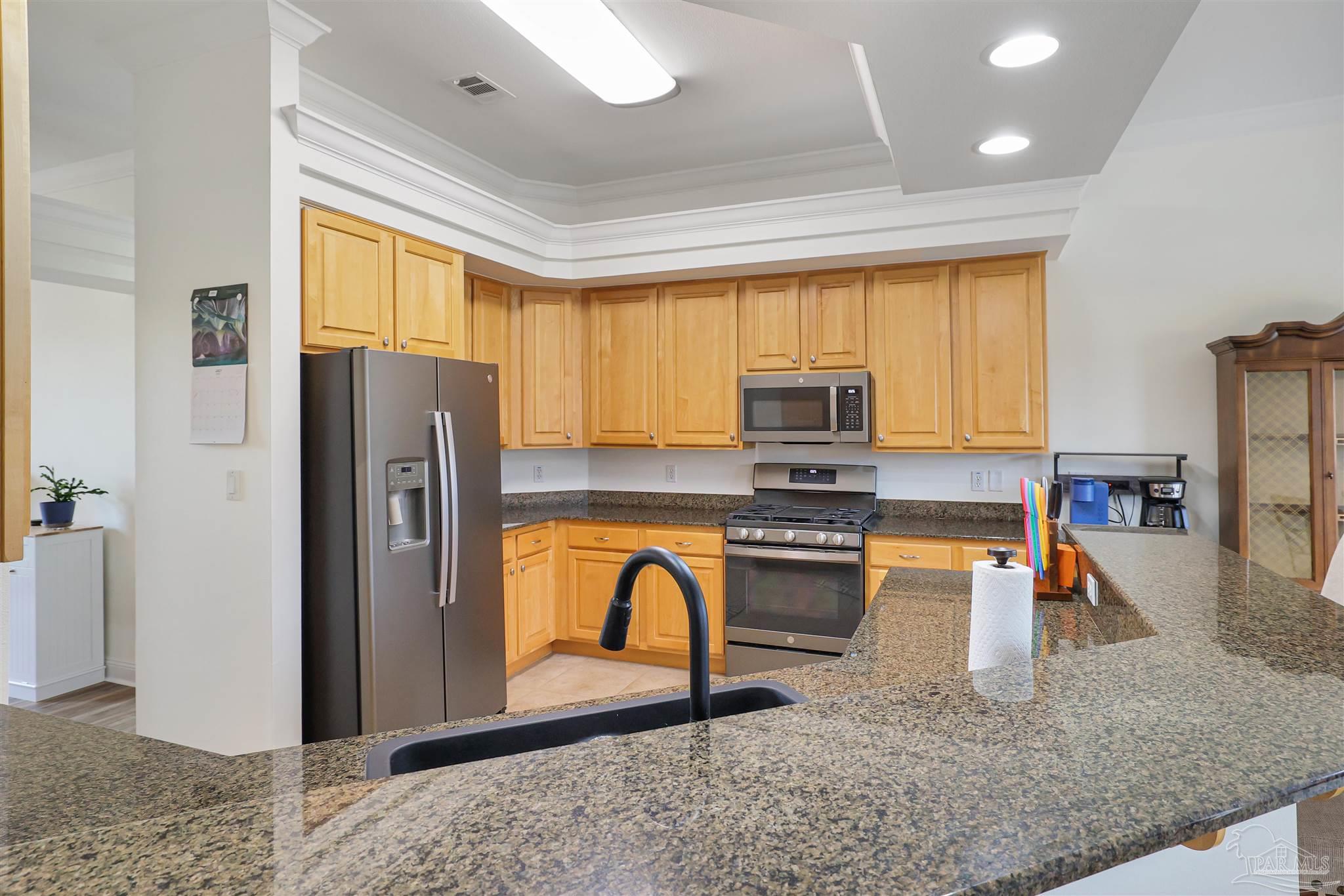 2822 Frederick Street Cantonment, FL 32533 - Photo 9 of 42 a view of kitchen with stainless steel appliances granite countertop sink refrigerator and microwave